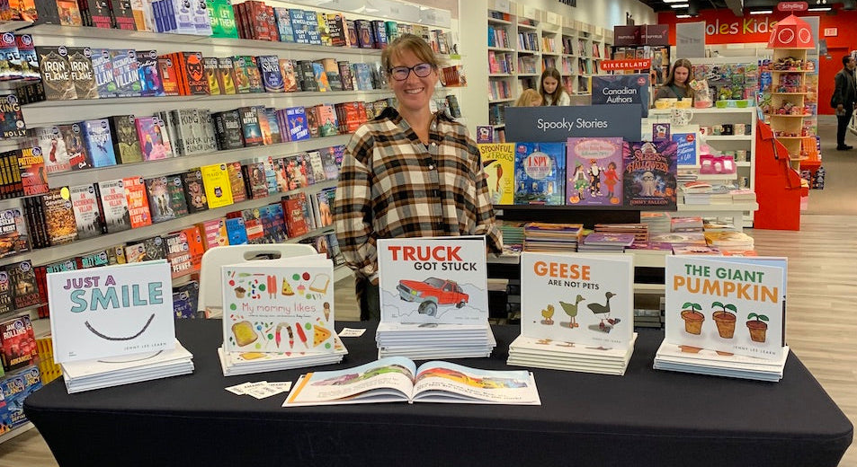 Jenny Lee Learn standing with her Amabel Books on a table in Indigo 